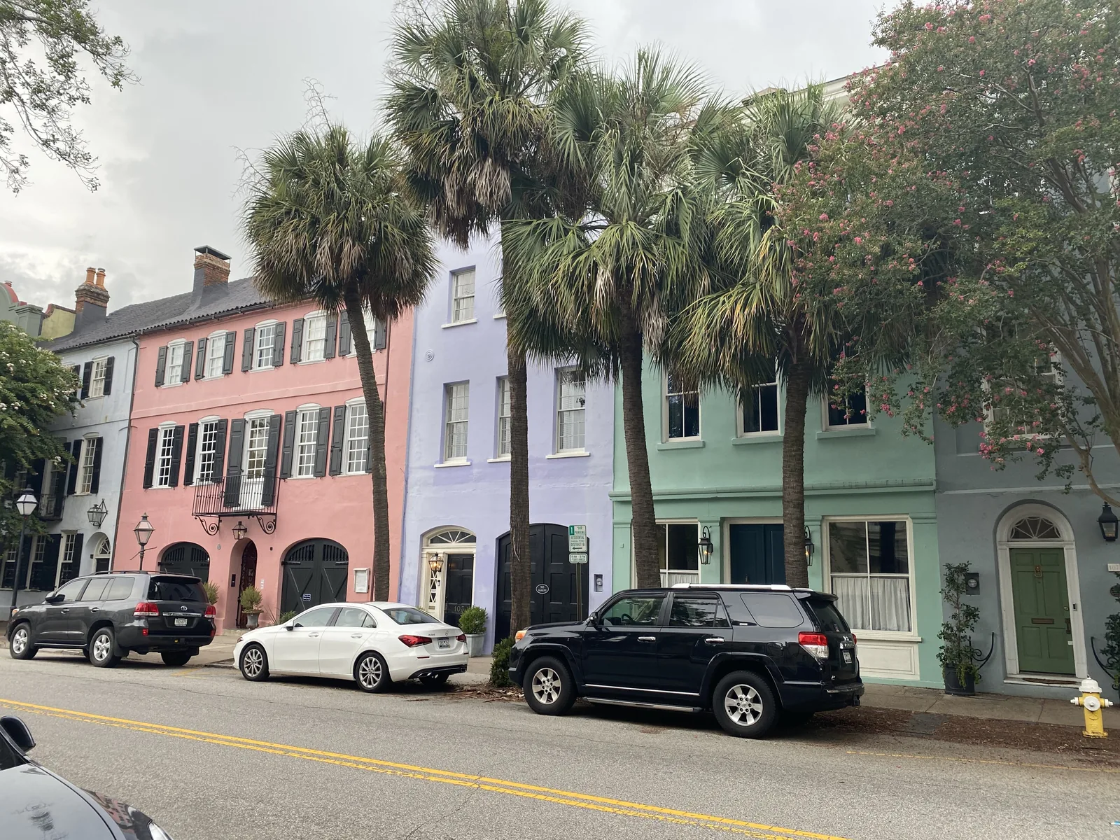 Pastel pink, blue and green historic houses of Rainbow Row on East Bay Street in Charleston, South Carolina