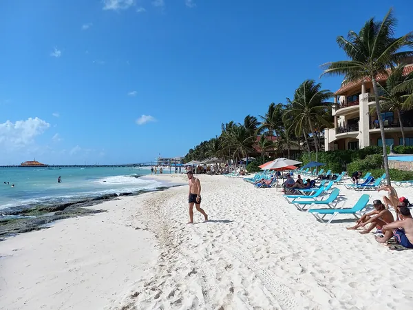 Sunny beach with palms at Playa del Carmen