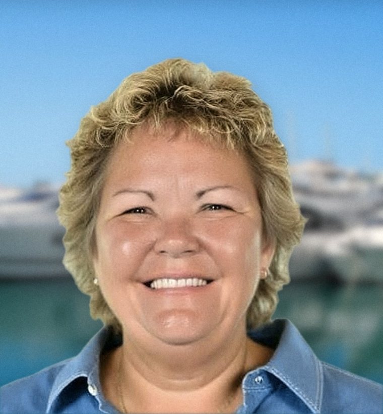 Karen Murphy, owner of Infinity Premier Travel, smiling at a marina